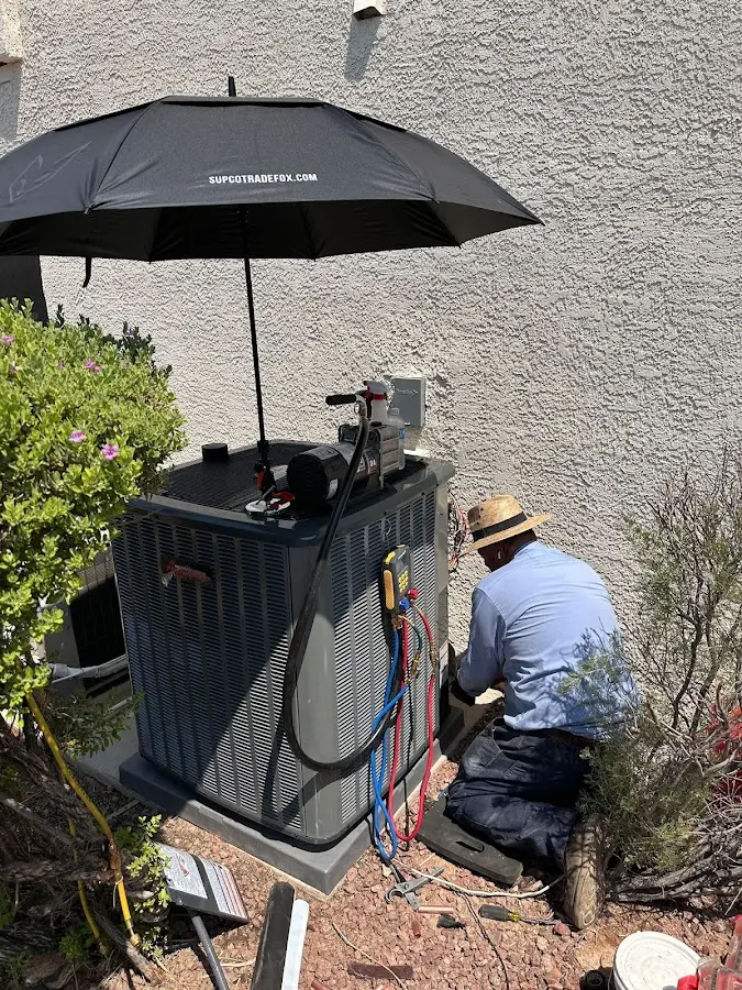 HVAC technician performing outdoor AC maintenance in Silsbee